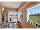 Charming sunroom featuring wood-paneled walls, multiple windows with backyard views, and a white French door at 68251 E 96Th Ave, Byers, CO 80103
