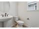 Cozy powder room featuring modern fixtures, vanity sink, and bright lighting at 9243 Truckee Ct, Commerce City, CO 80022