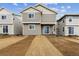 Newly built two-story home with neutral siding and a well-maintained lawn at 9243 Truckee Ct, Commerce City, CO 80022