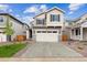Charming two-story home features a two-car garage, landscaped yard, and a welcoming front entrance at 9243 Truckee Ct, Commerce City, CO 80022