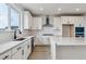 Stylish kitchen with white cabinets, center island, modern appliances, and ample counter space at 9243 Truckee Ct, Commerce City, CO 80022