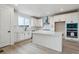 Stylish kitchen with white cabinets, center island, modern appliances, and ample counter space at 9243 Truckee Ct, Commerce City, CO 80022