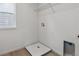 Bright laundry room with laminate flooring and laundry sink at 9243 Truckee Ct, Commerce City, CO 80022