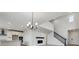 Bright, open-concept living area featuring fireplace and open kitchen with a large island at 9243 Truckee Ct, Commerce City, CO 80022