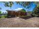 The backyard features a covered patio and space, providing a perfect area for outdoor entertaining and relaxation at 392 Central Ave, Brighton, CO 80601