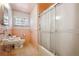 Full bathroom featuring a shower, toilet, sink with tiles, and a window, offering a vintage feel at 392 Central Ave, Brighton, CO 80601