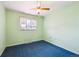 Simple bedroom featuring blue carpet, a window and light green walls at 392 Central Ave, Brighton, CO 80601