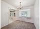 Bright dining room featuring chandelier lighting and neutral carpet at 392 Central Ave, Brighton, CO 80601