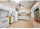 Functional kitchen with white cabinets, laminate counters, and matching appliances at 392 Central Ave, Brighton, CO 80601