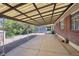 Covered patio with concrete floor and mature landscaping providing an outdoor area for relaxing and entertaining at 392 Central Ave, Brighton, CO 80601