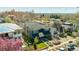 Aerial shot of a charming home with a manicured lawn and blooming trees in a neighborhood setting at 2978 Osceola St, Denver, CO 80212