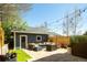 Backyard featuring patio with comfortable seating, string lights, fenced-in yard, and landscaping at 2978 Osceola St, Denver, CO 80212