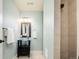 Bathroom features a glass sink, modern vanity, lighted mirror and shower with tile surround at 2978 Osceola St, Denver, CO 80212