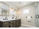 Modern bathroom featuring double sinks, white countertops, and a glass-enclosed shower at 2978 Osceola St, Denver, CO 80212
