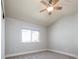 This bedroom features neutral walls, carpet, a ceiling fan, and a window letting in natural light at 2978 Osceola St, Denver, CO 80212