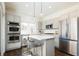 Open kitchen featuring stainless steel appliances, a center island, and barstool seating at 2978 Osceola St, Denver, CO 80212