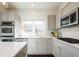 Contemporary kitchen featuring double ovens, a gas range, and stylish subway tiling at 2978 Osceola St, Denver, CO 80212