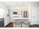 Well-lit kitchen with stainless steel appliances, white subway tile, and island seating at 2978 Osceola St, Denver, CO 80212