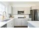 Modern kitchen with grey cabinetry, stainless appliances, and sleek quartz countertops at 2978 Osceola St, Denver, CO 80212