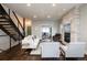 Stylish open living space with modern staircase, fireplace, and contemporary furniture at 2978 Osceola St, Denver, CO 80212