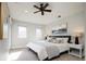 Relaxing main bedroom with a ceiling fan, a scenic painting and stylish bedside lamps at 2978 Osceola St, Denver, CO 80212