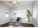Bright home office featuring a glass desk, modern furnishings, and a ceiling fan at 2978 Osceola St, Denver, CO 80212