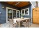 Covered patio with outdoor dining set, ceiling fan, and sliding glass doors for indoor-outdoor living at 2978 Osceola St, Denver, CO 80212
