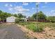 Large backyard featuring a detached garage, shed, and pergola, with potential for landscaping at 5935 Blanca Ct, Golden, CO 80403