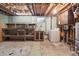 Unfinished basement featuring utility sink, washer, shelving, and ample storage space at 5935 Blanca Ct, Golden, CO 80403