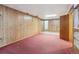 Large basement with wood paneling, a doorway, and a large storage room at 5935 Blanca Ct, Golden, CO 80403