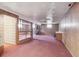 Spacious basement featuring a rustic wood-burning stove and wood paneled walls at 5935 Blanca Ct, Golden, CO 80403