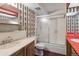 Bathroom with a combined shower/tub, a marble countertop sink, and custom wallpaper at 5935 Blanca Ct, Golden, CO 80403