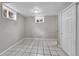 Functional basement space with tiled floors, window views, and natural light at 2971 S Sheridan Blvd, Denver, CO 80227