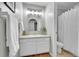 Bright bathroom featuring a white vanity with a sink, a large mirror, and a shower with a white curtain at 2971 S Sheridan Blvd, Denver, CO 80227