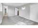 This bedroom has neutral walls, gray carpet, closet space and a pass-through leading to another room at 2971 S Sheridan Blvd, Denver, CO 80227