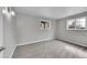 Neutral bedroom featuring soft gray walls, plush carpet, and windows offering natural light at 2971 S Sheridan Blvd, Denver, CO 80227