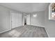 This bedroom has neutral walls, gray carpet, closet space and a window providing natural light at 2971 S Sheridan Blvd, Denver, CO 80227