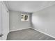 Comfortable bedroom with neutral gray walls, plush gray carpet, a bright window, and a closet at 2971 S Sheridan Blvd, Denver, CO 80227