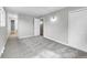 Bright bedroom with gray walls and plush carpet, featuring connecting doors and natural light at 2971 S Sheridan Blvd, Denver, CO 80227