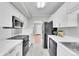 Updated kitchen featuring stainless steel appliances and plenty of counter space at 2971 S Sheridan Blvd, Denver, CO 80227