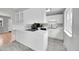 Bright white kitchen with stone countertops, stainless appliances, and a large window for natural light at 2971 S Sheridan Blvd, Denver, CO 80227