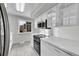 Stylish kitchen featuring a stainless steel microwave and oven and white stone countertops at 2971 S Sheridan Blvd, Denver, CO 80227