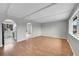 Bright living room with hardwood floors, arched doorways, and ample natural light from the large window at 2971 S Sheridan Blvd, Denver, CO 80227