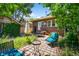 Charming backyard featuring brick pavers, comfortable seating, and beautiful landscaping at 836 Steele St, Denver, CO 80206