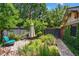 Secluded backyard patio area with elegant seating, decorative landscaping, and privacy fencing at 836 Steele St, Denver, CO 80206