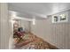 Finished basement offering cozy seating, built-in shelving, and a large window for natural light at 836 Steele St, Denver, CO 80206