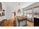 Bright dining room with hardwood floors, stylish lighting, and large windows at 836 Steele St, Denver, CO 80206