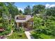 Charming brick home featuring a well-manicured lawn, mature trees, and inviting front porch at 836 Steele St, Denver, CO 80206