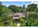 Exterior view of a brick house surrounded by lush greenery, and a cozy front porch at 836 Steele St, Denver, CO 80206