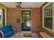 Charming front porch with brick, natural light, and cozy seating area at 836 Steele St, Denver, CO 80206